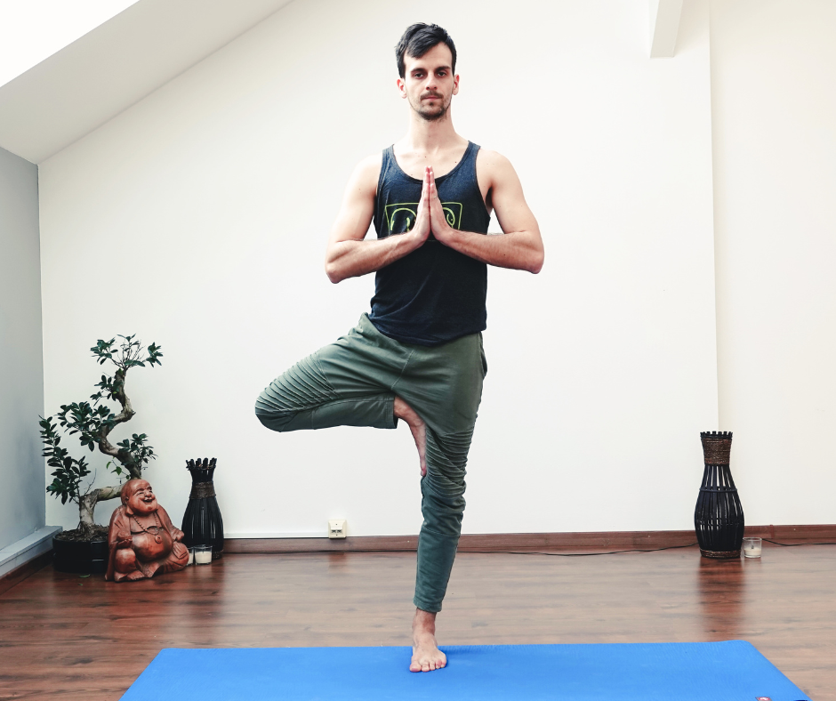 man doing yoga pose standing on one leg